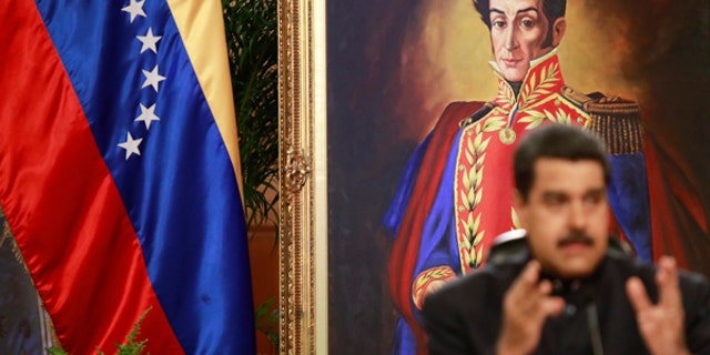A painting of South American independence leader Simon Bolivar is seen as Venezuela's President Nicolas Maduro talks to the media during a news conference at Miraflores Palace in Caracas, Venezuela June 22, 2017.