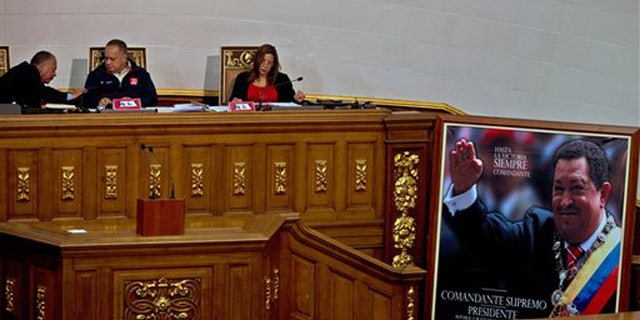 President of National Assembly, Diosdado Cabello, center, speaks with the first Vice President Elvis Amoroso, left, next to the second Vice President Tania Diaz, during a session in Caracas, Venezuela, Thursday, Dec. 10, 2015. Venezuela's ruling socialist party is set to rush through a series of appointments before the opposition takes over congress next month with promises to revive what it calls a moribund institution. The legislature was expected to name 12 Supreme Court justices Thursday during a final session, filling vacancies left by a group of judges who requested early retirement. (AP Photo/Fernando Llano)