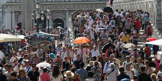 Aug. 3, 2017: Tourists walk near St. Mark's Square in Venice, Italy.