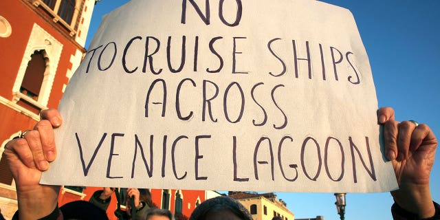 A person is seen protesting the transit of the cruises into the Venice lagoon back in 2012.