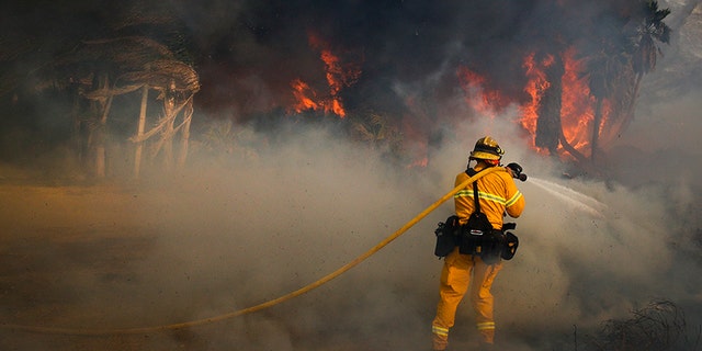 Dec. 7, 2017: A firefighter battles a wildfire at Faria State Beach in Ventura, Calif.
