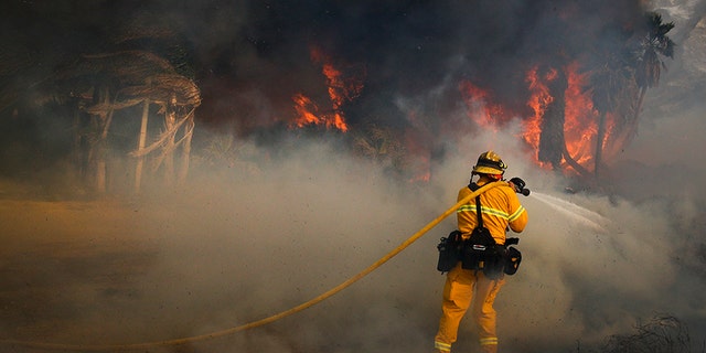 Dec. 7, 2017: A firefighter battles a wildfire at Faria State Beach in Ventura, Calif.