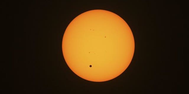 June 6, 2012: This photo taken through viewing glasses shows Venus crossing the sun in Sydney, Australia.