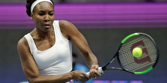 Venus Williams of the U.S. returns the ball to Kristina Mladenovic of France during the St. Petersburg Ladies Trophy-2017 tennis tournament match in St. Petersburg, Russia, Thursday, Feb. 2, 2017. (AP Photo/Dmitri Lovetsky)