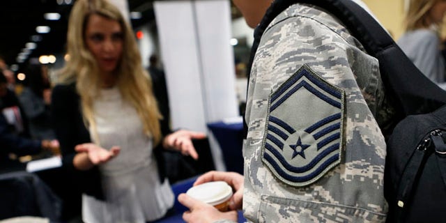 FILE: January 10, 2014: An Air Force sergeant talks with a recruiter at the Hiring Our Heroes job fair in Washington, D.C.