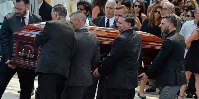Mourners carry the casket of Karina Vetrano from St. Helen's Church after her funeral in August 2016.