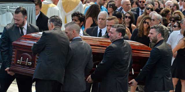 Mourners carry the casket of Karina Vetrano from St. Helen's Church after her funeral in August 2016.