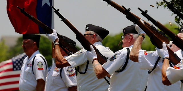 Shell casings eject from the rifles of the Fort Sam Houston Memorial Services Detachment Honor Guard as they fire three volleys during a burial service by Fort Sam Houston National Cemetery and the Missing In America Project for the cremated remains of eight unclaimed veterans in San Antonio, June 1, 2018.