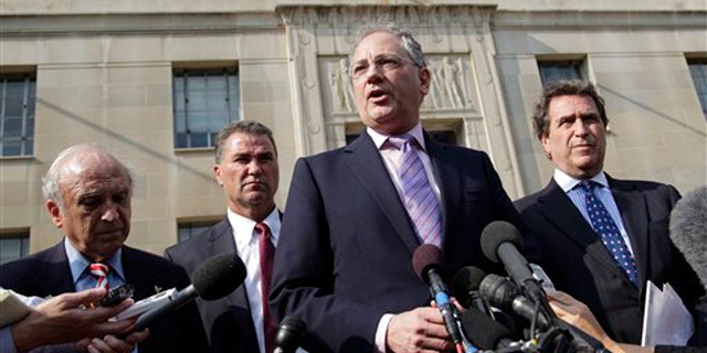 Relatives of victims of the Sept. 11 attacks in New York speak with reporters outside the Justice Department in Washington after a meeting with Attorney General Eric Holder Aug. 24.