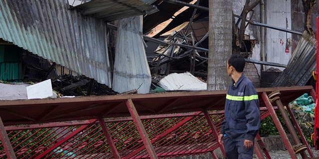 May 14, 2014; A man looks at the damaged building of Taiwanese bicycle factory Tan Than in Di An Town, Binh Duong Province, Vietnam. (AP)