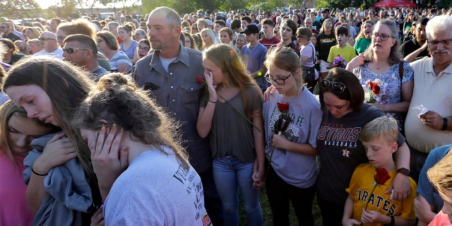 Mourners gather during a prayer vigil following a shooting at Santa Fe High School in Santa Fe, Texas on Friday.