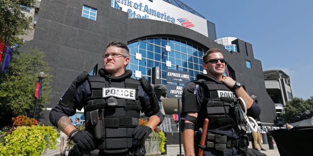 Charlotte-Mecklenburg Police officers stand guard outside Bank of America Stadium.