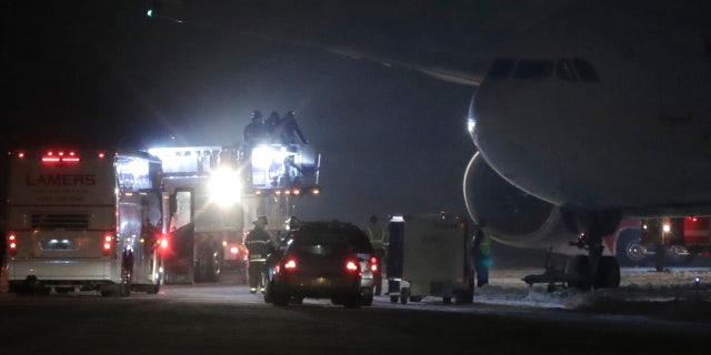 Players, coaches and staff from the Minnesota Vikings are taken off a plane in small groups at Appleton International Airport on Friday, Dec. 23, 2016, in Appleton, Wis.