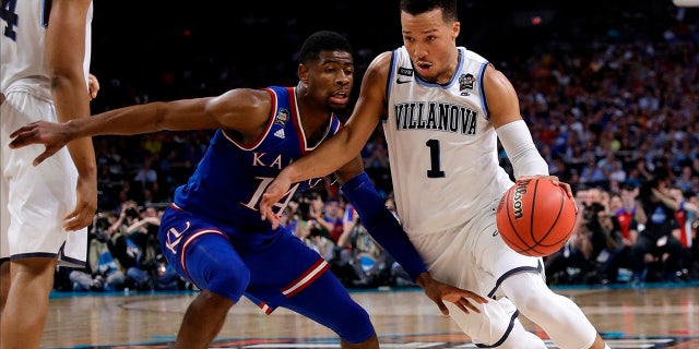 Villanova guard Jalen Brunson (1) drives past Kansas guard Malik Newman during Saturday's NCAA semifinal in San Antonio.