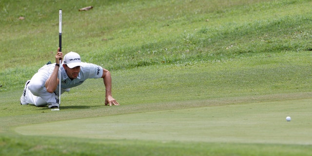 Camilo Villegas of Colombia lines up his putt on the 8th green during the third round of the Asia Pacific Classic Malaysia golf tournament at The Mines Resort &amp; Golf Club in Kuala Lumpur, Malaysia, Saturday, Oct. 29, 2011. (AP Photo/Lai Seng Sin)