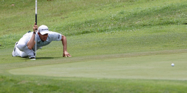 Camilo Villegas of Colombia lines up his putt on the 8th green during the third round of the Asia Pacific Classic Malaysia golf tournament at The Mines Resort & Golf Club in Kuala Lumpur, Malaysia, Saturday, Oct. 29, 2011. (AP Photo/Lai Seng Sin)