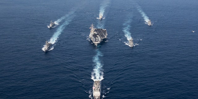 The Nimitz-class aircraft carrier USS Carl Vinson (CVN 70), the Arleigh Burke-class guided-missile destroyer USS Wayne E. Meyer (DDG 108) and the Ticonderoga-class guided-missile cruiser USS Lake Champlain (CG 57) in a photo exercise with Japan Maritime Self-Defense Force destroyers.