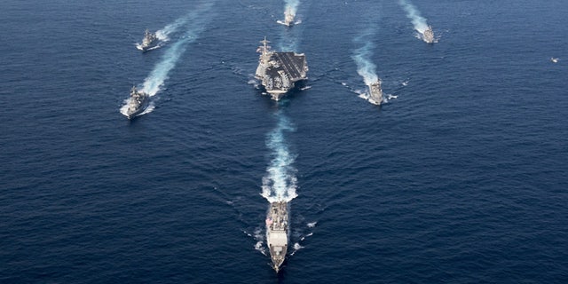 The Nimitz-class aircraft carrier USS Carl Vinson (CVN 70), the Arleigh Burke-class guided-missile destroyer USS Wayne E. Meyer (DDG 108) and the Ticonderoga-class guided-missile cruiser USS Lake Champlain (CG 57) in a photo exercise with Japan Maritime Self-Defense Force destroyers.