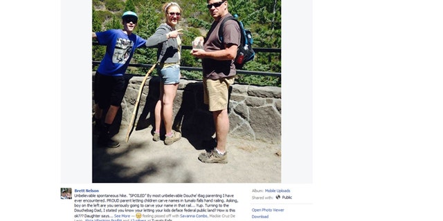 An angry hiker posted this photo online after allegedly seeing the subjects carving initials into a railing.