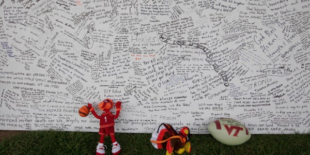In this April 28, 2007 file photo, a memorial board sits under a tent with items that were placed in front of it, on the Drillfield on the Virginia Tech campus in Blacksburg, Va.
