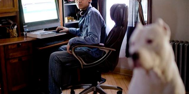 High school student Vito Calli, 15, poses for a portrait by his computer, Wednesday, Nov. 20, 2013, at his home in Reading, Pa. In a shift in attitude, most young people now say it's wrong to use racist or sexist slurs online, even if you're just kidding. But when they see them, they don't take much personal offense. Calli, whose family emigrated from Argentina, says people tease him online with jokes about Hispanics, but "you can't let those things get to you." (AP Photo/Matt Rourke)