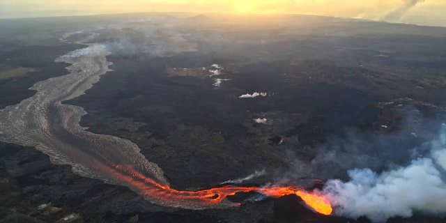 Sunrise above Kīlauea's lower East Rift Zone in Hawaii on July 17, 2018. The volcano's fissure 8 continues to feed a channelized lava flow that reaches the ocean.