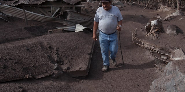 Efrain Suarez walks through a barren terrain near the Volcan de Fuego, or "Volcano of Fire," in San Miguel Los Lotes, Guatemala on Wednesday.