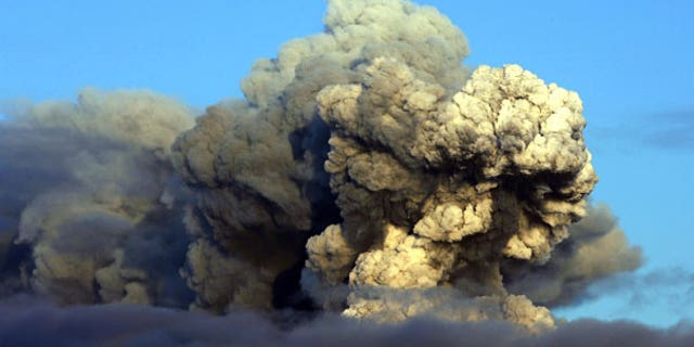April 16: The volcano in southern Iceland's Eyjafjallajokull glacier sends ash into the air just prior to sunset. (AP)