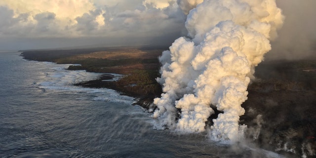 A laze plume rises where lava pours into the sea from fissure 8 on Hawaii's Big Island.