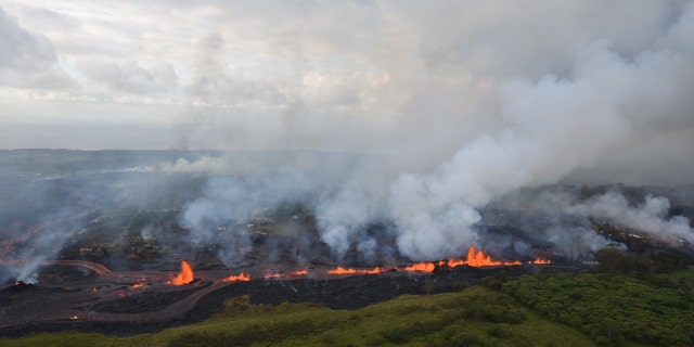 Lava flows downhill in this helicopter overflight image of Kilauea Volcano's lower East Rift zone during ongoing eruptions in Hawaii.