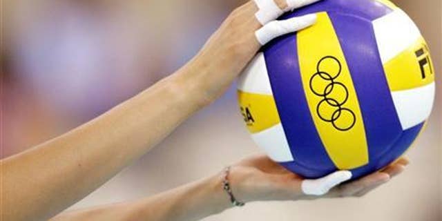An unidentified Japanese player prepares to serve during a women's team pratice session at the Peace and Friendship Olympic stadium in Athens August 11, 2004. REUTERS/Jorge Silva