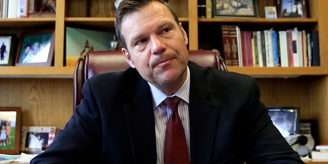 FILE - In this May 17, 2017, file photo, Kansas Secretary of State Kris Kobach talks with a reporter in his office in Topeka, Kan. Kobach, the vice chair of President Donald Trump's election fraud commission is taking issue with reports that a majority of states are refusing to comply with a request for voter information. Kobach says that news stories stating that 44 states have "refused" to provide voter information to the commission are "patently false."(AP Photo/Orlin Wagner, File)