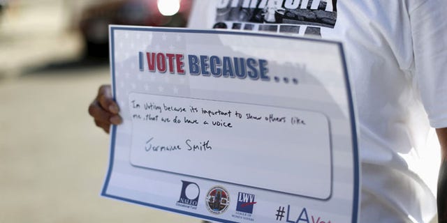 FILE: Sept. 22, 2015: A person holds a sign after registering to vote during National Voter Registration Day in Los Angeles, Calif. (Reuters)