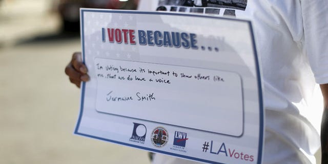 FILE: Sept. 22, 2015: A person holds a sign after registering to vote during National Voter Registration Day in Los Angeles, Calif. (Reuters)