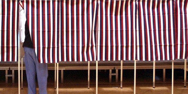FILE: Feb. 2004: Voter in voting booth during Super Tuesday primary, Montpellier, Vt.