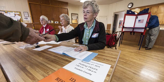 CENTROPOLIS TOWNSHIP, KS -  NOVEMBER 4: Election worker Karen Witham checks voter identifications in the Richter Church November 4, 2014 in Centropolis Township, near Ottawa, Kansas. A tight race between independent candidate, Greg Orman (I-KS) and U.S. Sen. Pat Roberts (R-KS) brought voters to the polls in the Kansas midterm elections. (Photo by Julie Denesha/Getty Images)