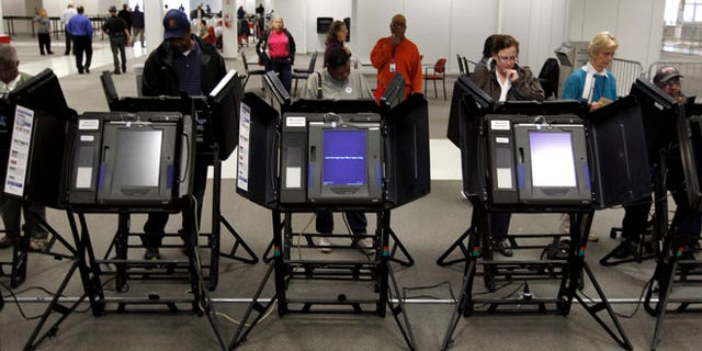 Oct. 2, 2012: Voters cast their ballots at a Franklin County polling location on the first day of in-person absentee voting in Columbus, Ohio.