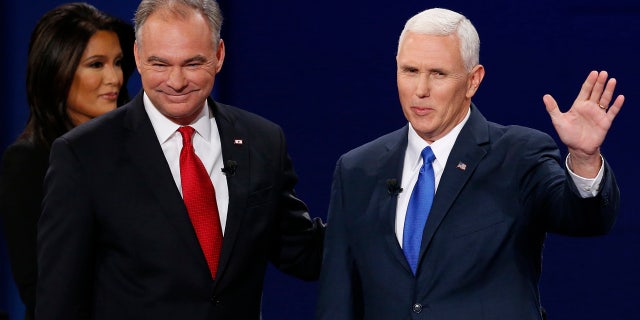 Republican vice-presidential nominee Gov. Mike Pence, right, and Democratic vice-presidential nominee Sen. Tim Kaine stand before the audience during the vice-presidential debate at Longwood University in Farmville, Va., Tuesday, Oct. 4, 2016. (AP Photo/Steve Helber)