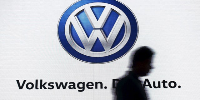 June 23, 2015: A man walks past a screen displaying a logo of Volkswagen at an event in New Delhi, India. (Reuters)
