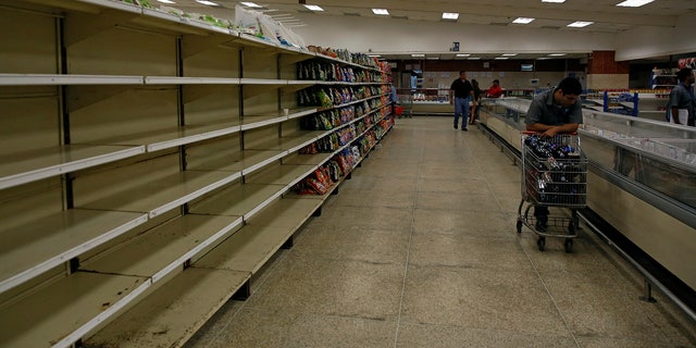 People buy food and other staple goods inside a supermarket in Caracas, Venezuela June 30, 2016.