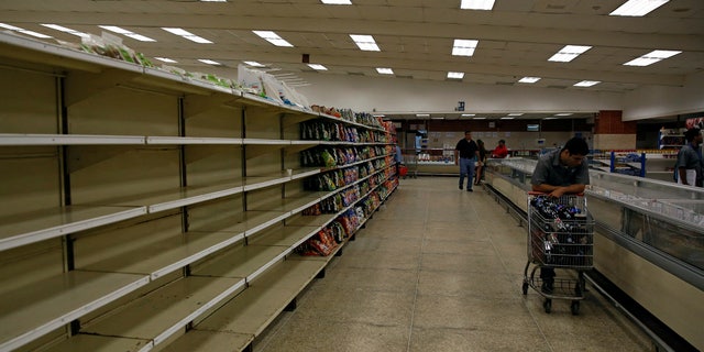 People buy food and other staple goods inside a supermarket in Caracas, Venezuela June 30, 2016.
