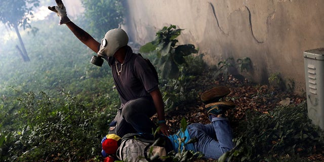 An injured demonstrators is been helped by another protester after clashing with riot police during the so-called "mother of all marches" against Venezuela's President Nicolas Maduro in Caracas, Venezuela April 19, 2017.