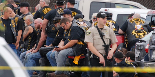 May 17, 2015: A McLennan County deputy stands guard near a group of bikers in the parking lot of a Twin Peaks restaurant, in Waco, Texas.