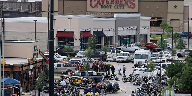In this May 17, 2015 file photo, authorities investigate a shooting in the parking lot of Twin Peaks restaurant in Waco, Texas.