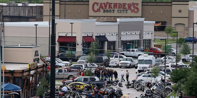 In this May 17, 2015 file photo, authorities investigate a shooting in the parking lot of Twin Peaks restaurant in Waco, Texas.