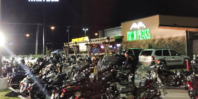 Police investigators search the scene at the Twin Peaks Restaurant in Waco, Texas.