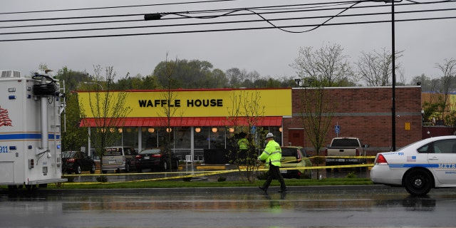 Metro Davidson County Police inspect the scene of a fatal shooting at a Waffle House restaurant.