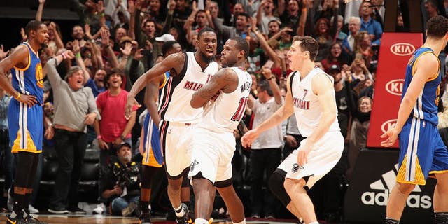 MIAMI, FL - JANUARY 23: Dion Waiters #11 of the Miami Heat celebrates with his team after making the game winning shot during the game against the Golden State Warriors on January 23, 2017 at American Airlines Arena in Miami, Florida. NOTE TO USER: User expressly acknowledges and agrees that, by downloading and or using this Photograph, user is consenting to the terms and conditions of the Getty Images License Agreement. Mandatory Copyright Notice: Copyright 2017 NBAE (Photo by Issac Baldizon/NBAE via Getty Images)