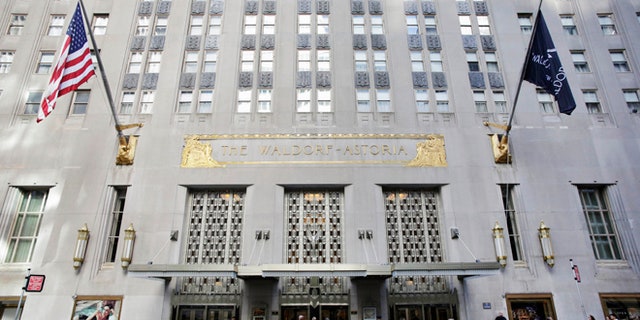 In this Oct. 6, 2014 file photo, a taxi passes in front of the Waldorf Astoria hotel in New York.