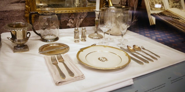A place setting is displayed behind glass in the small museum off the lobby of the Waldorf Astoria.